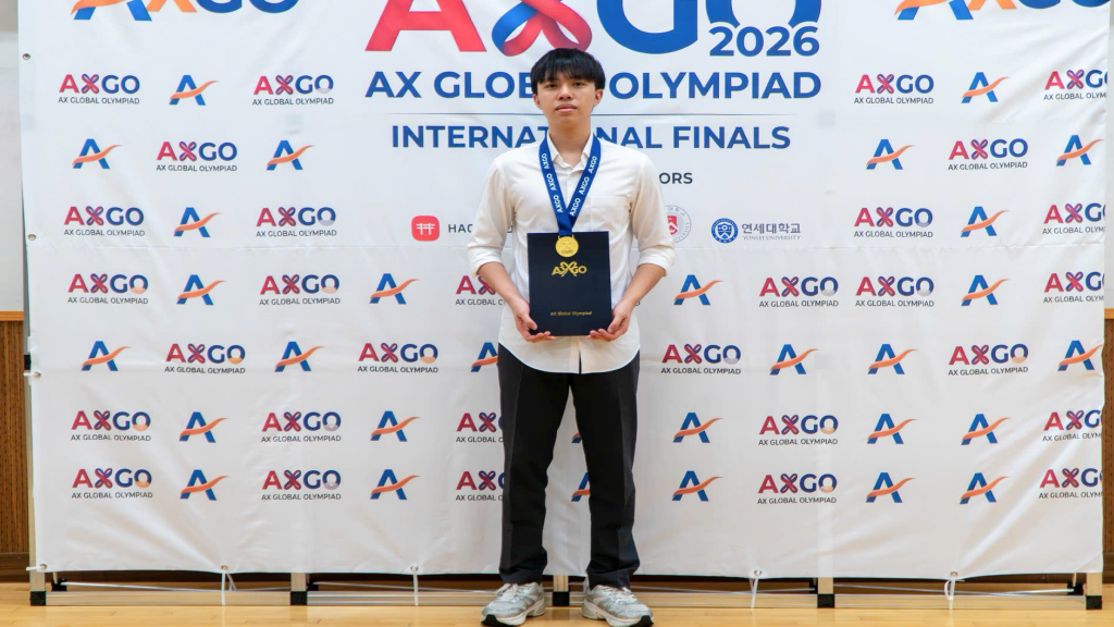 Khoi holding his award at the AX Global Olympiad.