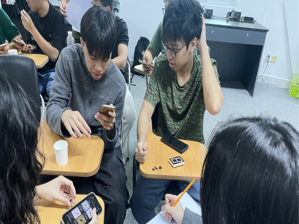 Khoi working with fellow students on an engineering project