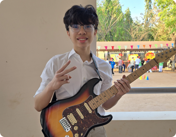 Khoi playing a string instrument outdoors